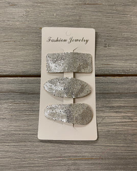 Silver felt backed snap clip set on card